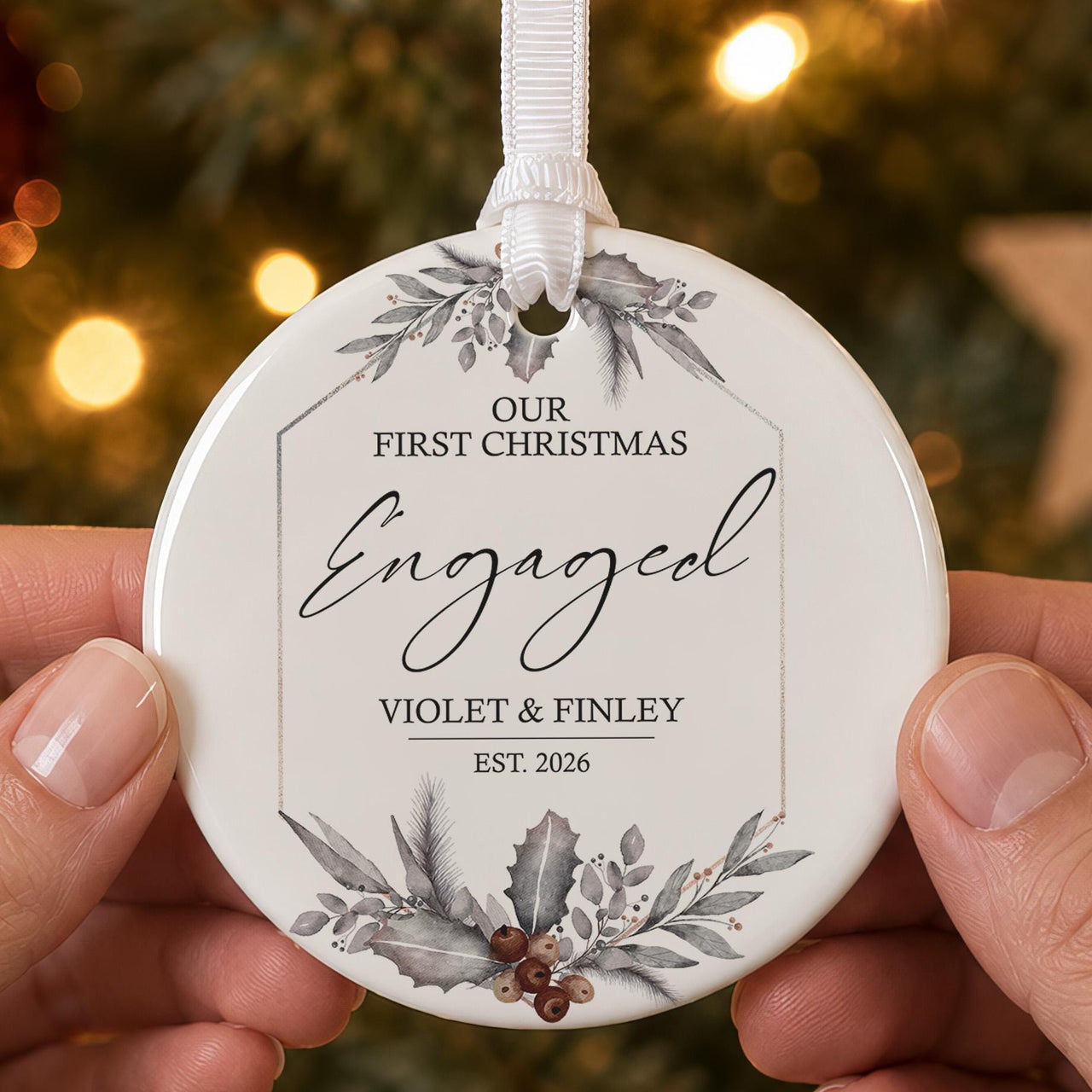 Engaged couple ceramic bauble: grey holly and berry frame, Our First Christmas Engaged, Violet & Finley, Est. 2026