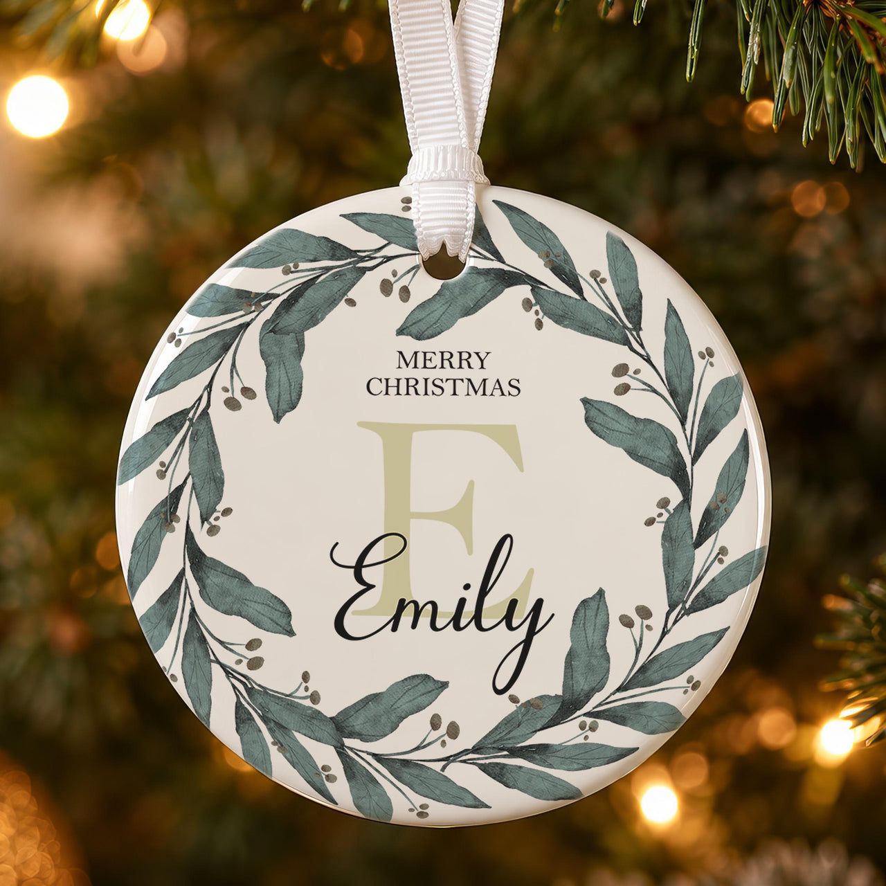 Initial wreath ceramic bauble: green watercolour leaf wreath, Merry Christmas, a large pale E and Emily in script