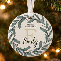 Initial wreath ceramic bauble: green watercolour leaf wreath, Merry Christmas, a large pale E and Emily in script