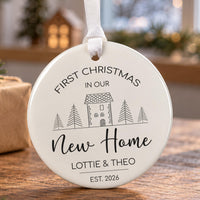 New home Christmas bauble: ceramic ornament with a line-art house between pine trees, New Home and Lottie & Theo