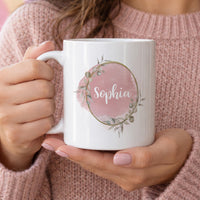 Personalised name mug: white mug with a blush pink watercolour circle, a gold leafy wreath and Sophia in white script