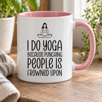 Funny yoga mug: pink-handled mug with a meditating woman and I DO YOGA BECAUSE PUNCHING PEOPLE IS FROWNED UPON