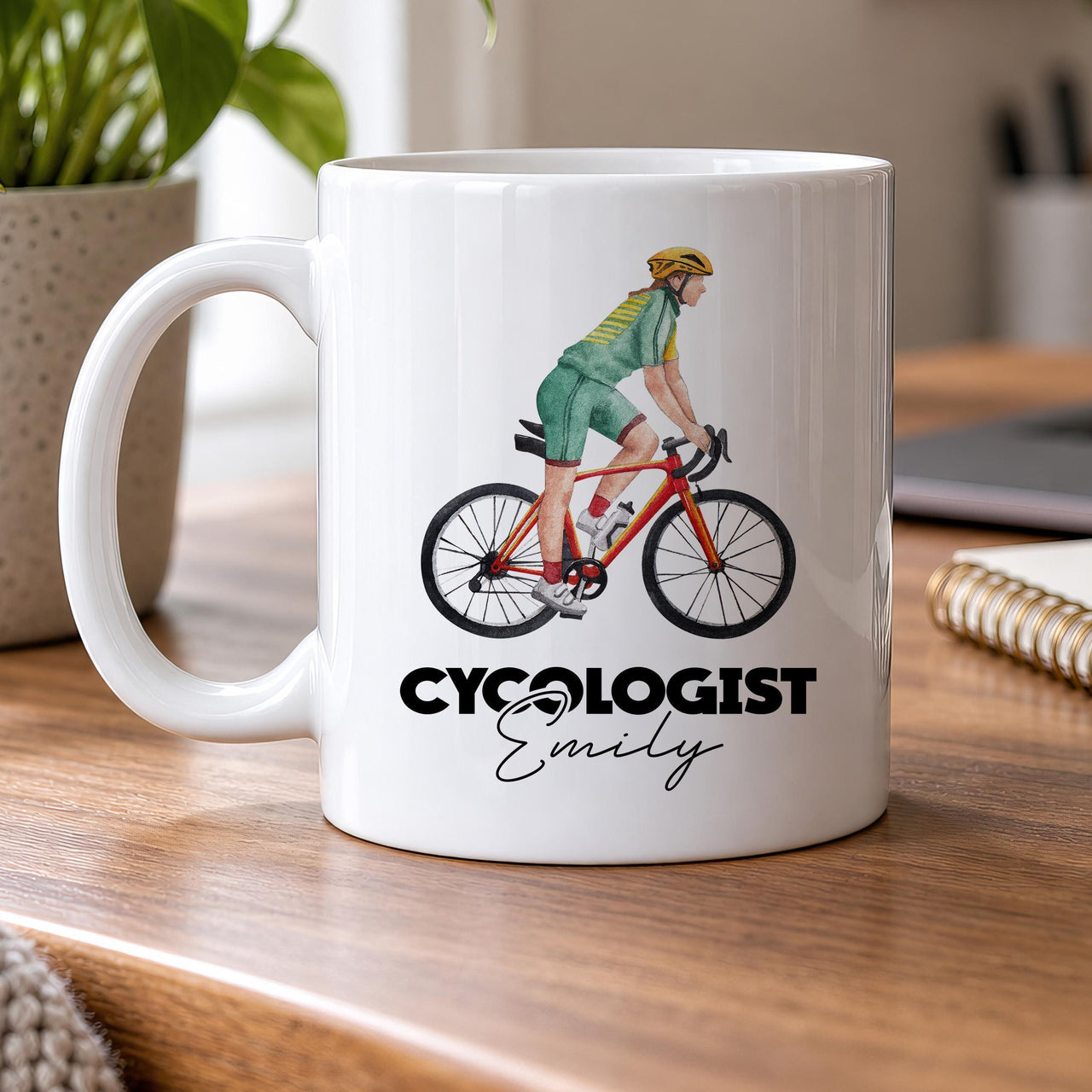 Personalised cyclist mug: white mug with a watercolour road cyclist on a red bike, CYCOLOGIST and Emily in script