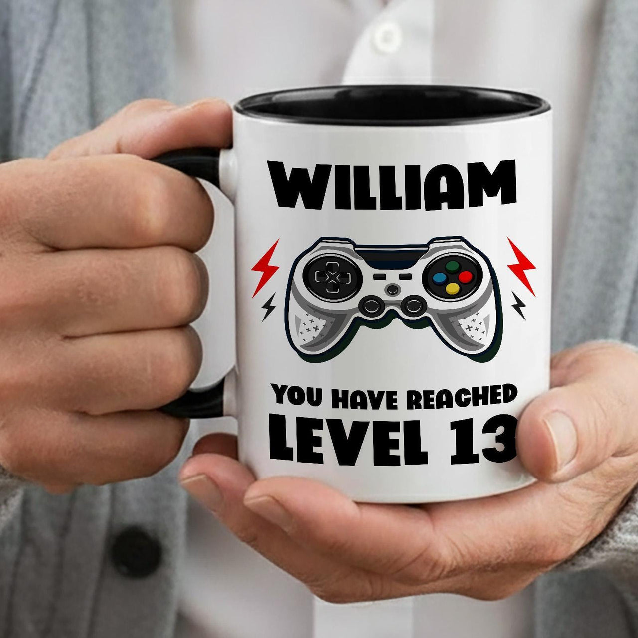 Personalised gamer birthday mug: black-handled mug with WILLIAM, a game controller and YOU HAVE REACHED LEVEL 13