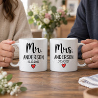 Mr and Mrs wedding mugs: two white mugs with Mr. and Mrs. in black script, ANDERSON, 20.10.2027 and a small red heart