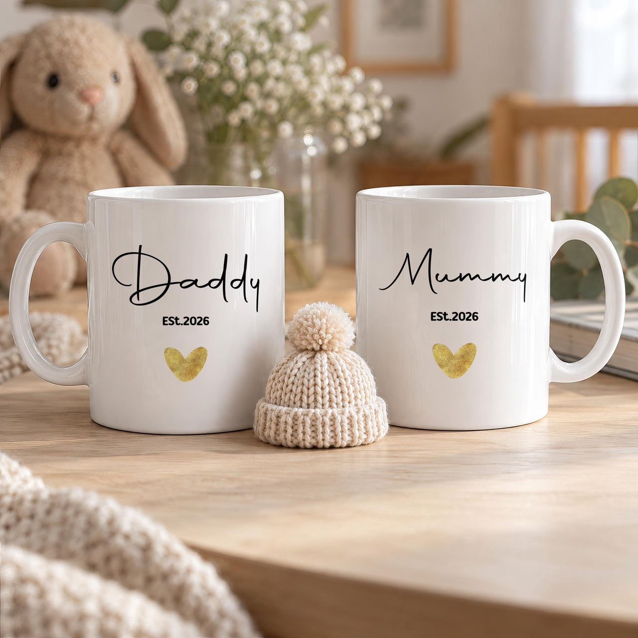 Personalised new parent mugs: two white mugs reading Daddy and Mummy in black script, Est.2026 and a gold heart
