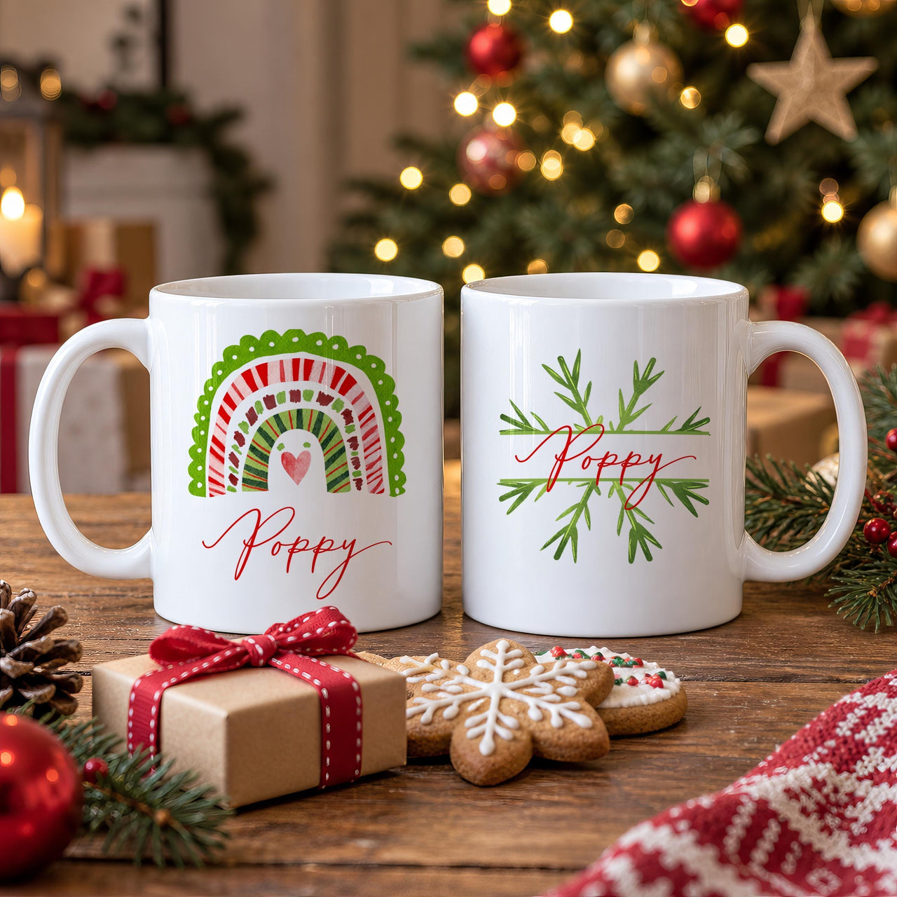 Personalised Christmas mugs: two white mugs, a red and green scalloped rainbow and a green snowflake, each with Poppy
