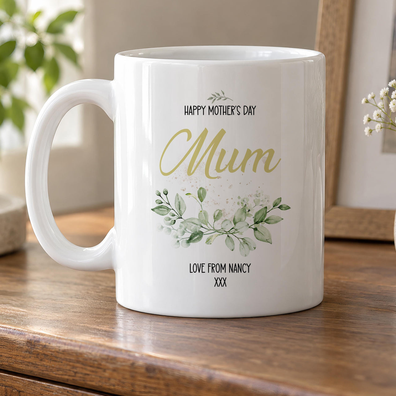 Mother's Day mug: white mug with Happy Mother's Day, Mum in gold script, watercolour green leaves and Love from Nancy xxx
