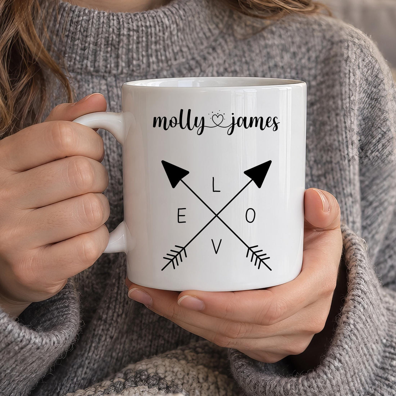 Personalised couple mug: white mug with crossed arrows spelling LOVE and the names molly and james joined by a heart