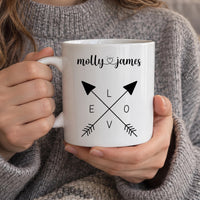 Personalised couple mug: white mug with crossed arrows spelling LOVE and the names molly and james joined by a heart