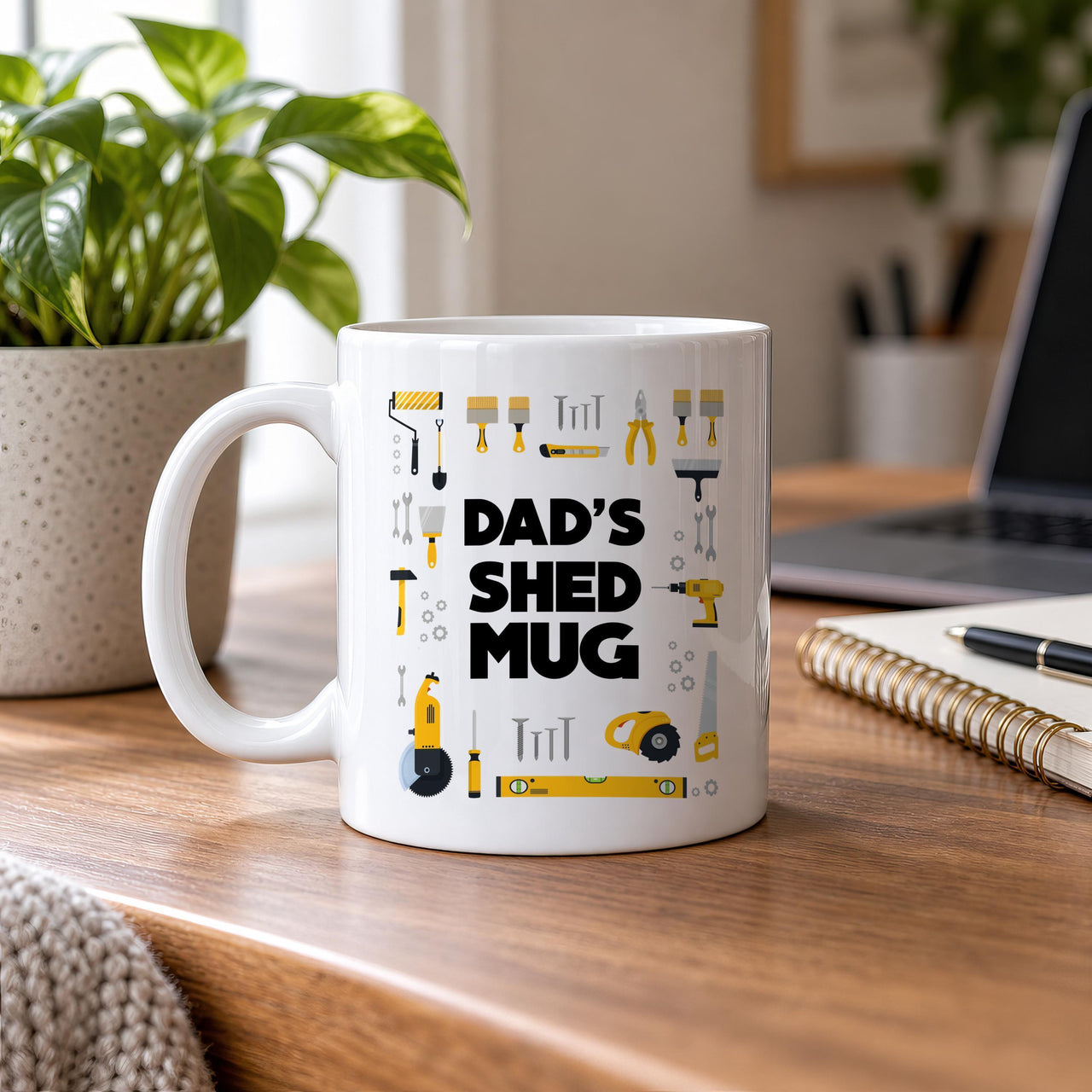 Dad's Shed mug in white on a wooden desk by a window