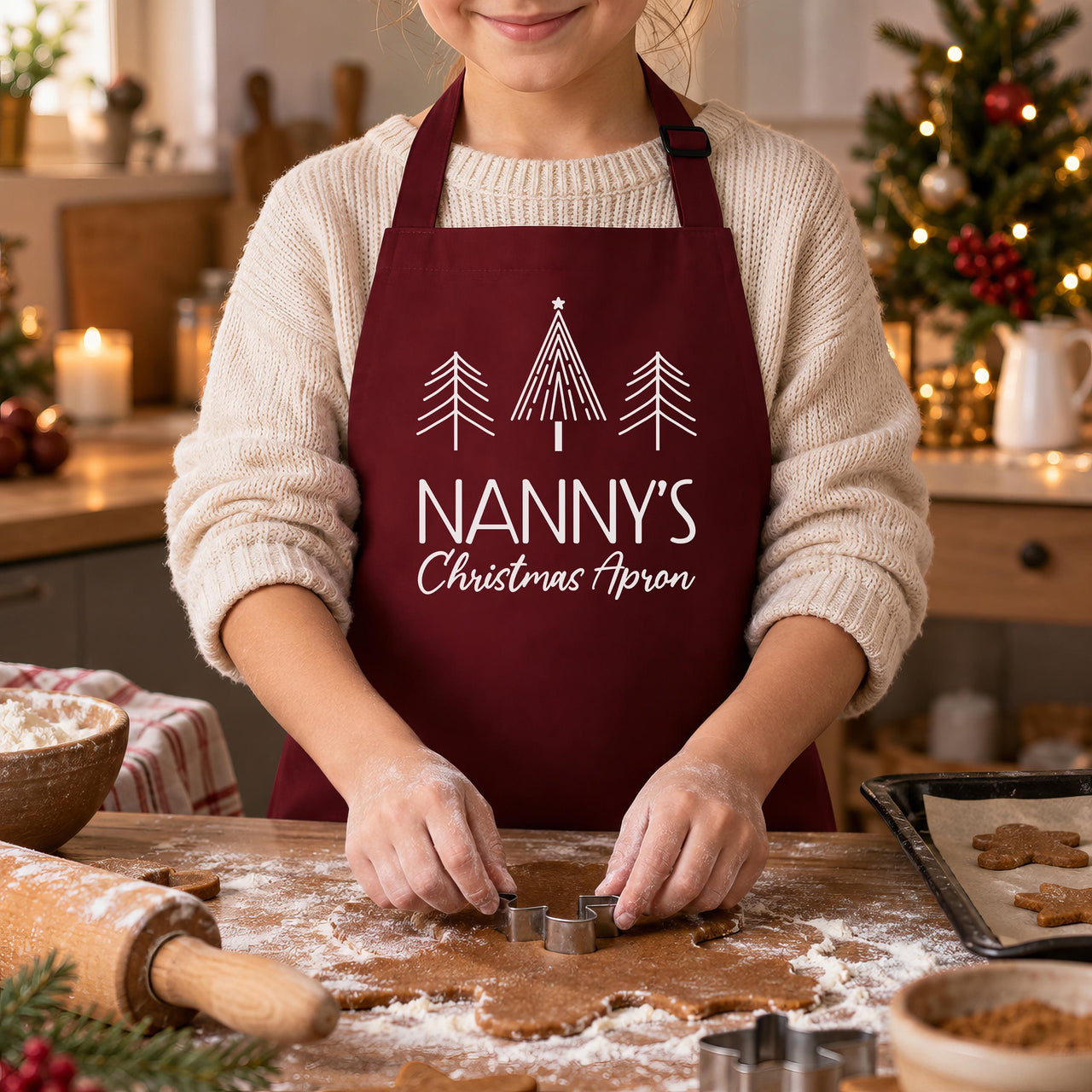 Burgundy Nanny's Christmas Apron, worn while cutting out gingerbread biscuits