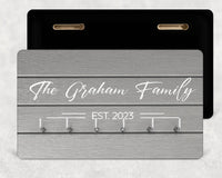 Grey wood-effect key rack with white script 