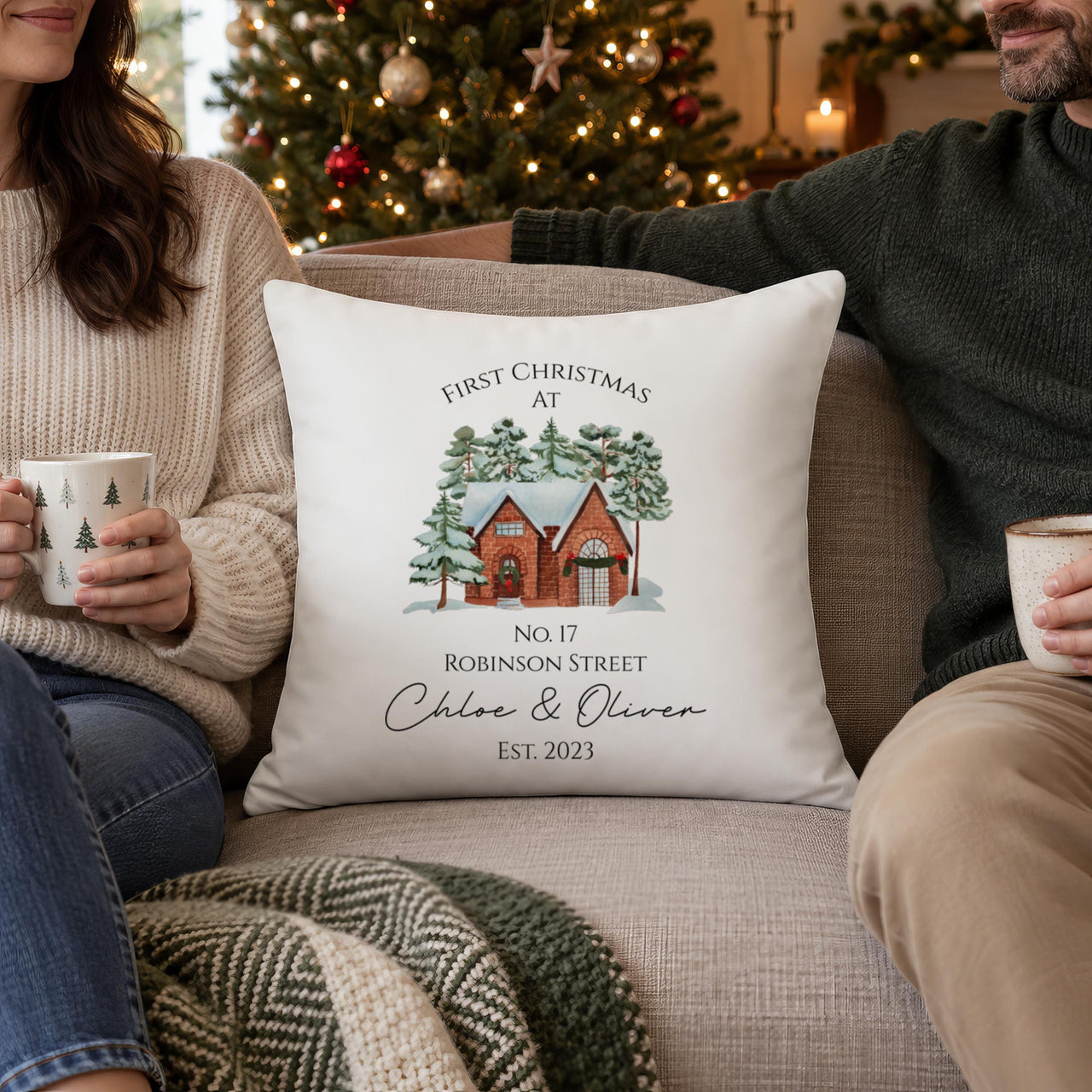 White cushion 'First Christmas At No. 17 Robinson Street', 'Chloe & Oliver Est. 2023' between a couple - personalised cushion