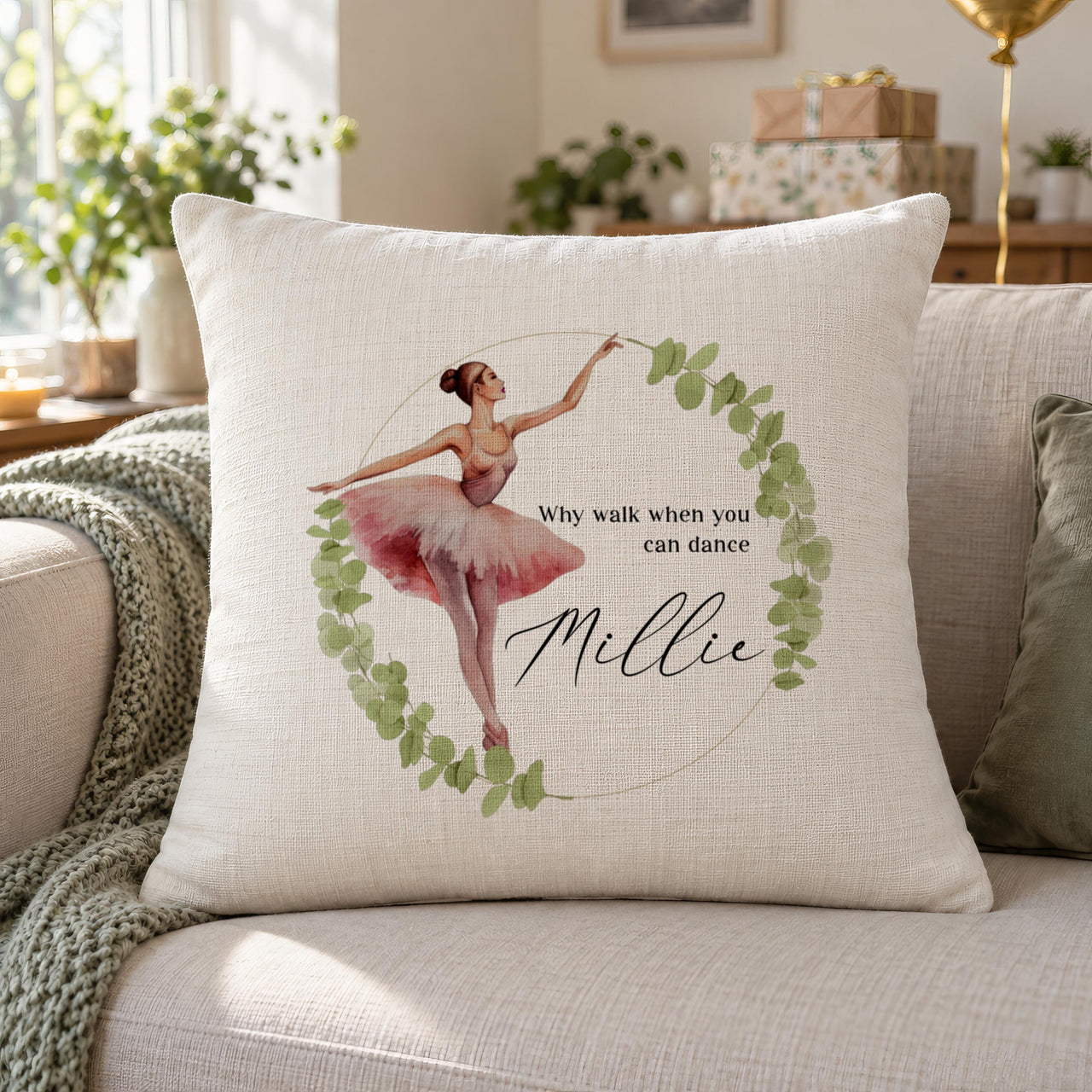 Cream cushion with a ballerina in a pink tutu inside a leaf wreath, the quote Why walk when you can dance and the name Millie