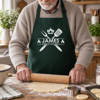 Older man rolling pastry in a bottle green apron printed 