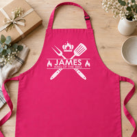 Pink apron laid flat on wood with pale 