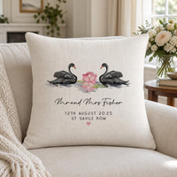 Linen-look cushion on a sofa, two black swans with a pink lotus and 'Mr and Mrs Fisher' wedding date - personalised cushion
