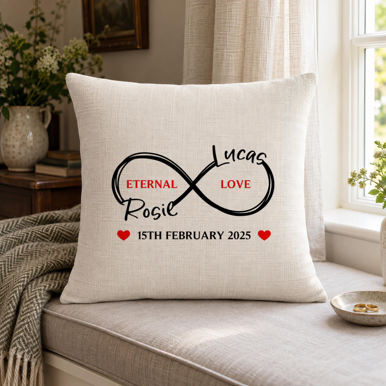 Cushion on a window seat with infinity loop, "Eternal Love", two names and "15th February 2025" - personalised cushion cover