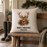 Linen-look cushion, reindeer in festive wreath, 'MERRY CHRISTMAS' and 'Matilda', on a wooden bench - personalised cushion