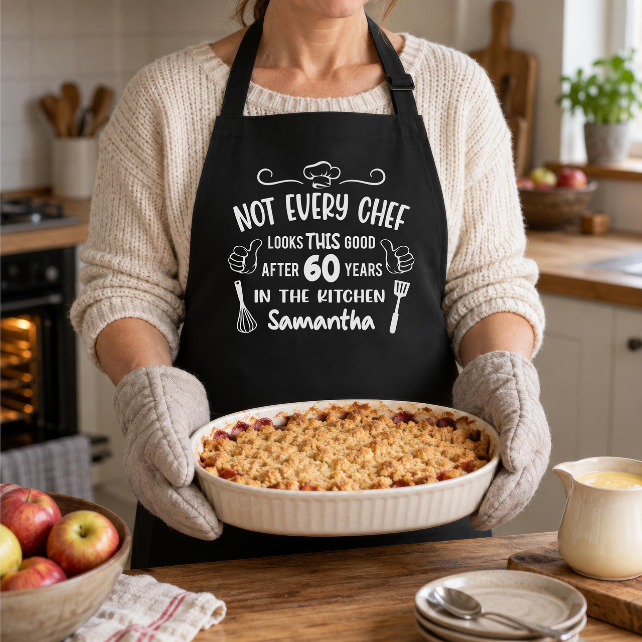 Black apron with white 'NOT EVERY CHEF' 60 years 'Samantha' design, woman holding a fruit crumble - personalised apron
