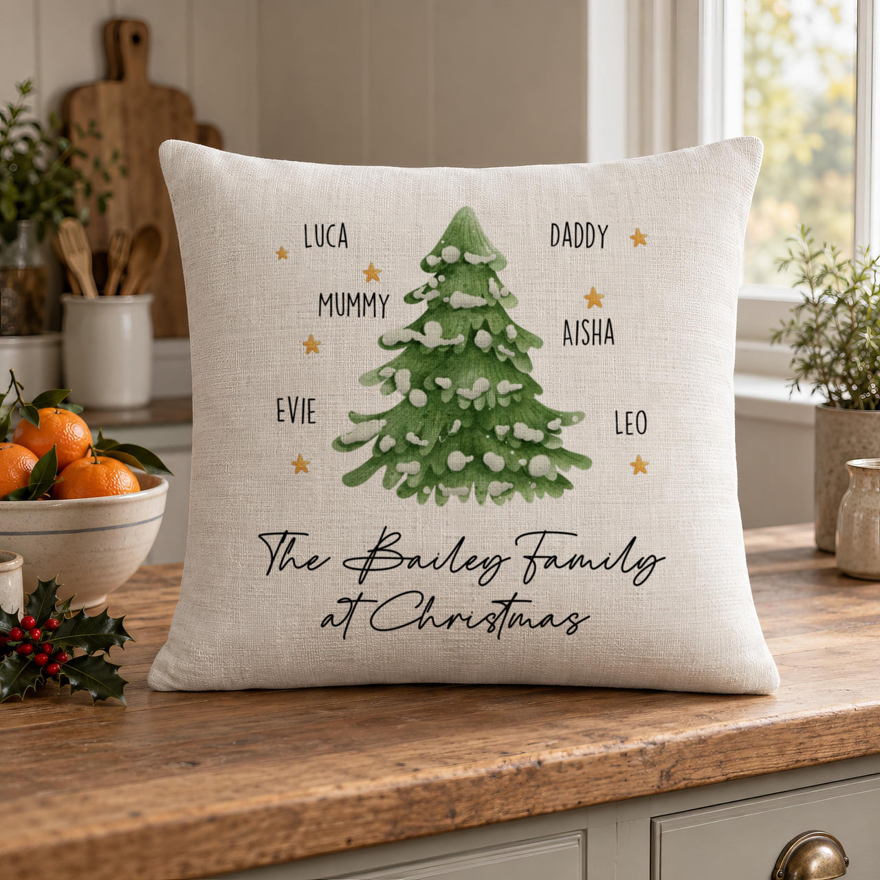 Linen-look 'The Bailey Family at Christmas' tree cushion with gold stars on a kitchen worktop - personalised cushion
