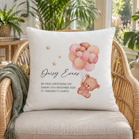Personalised christening bear cushion with name, date and church on a wicker chair