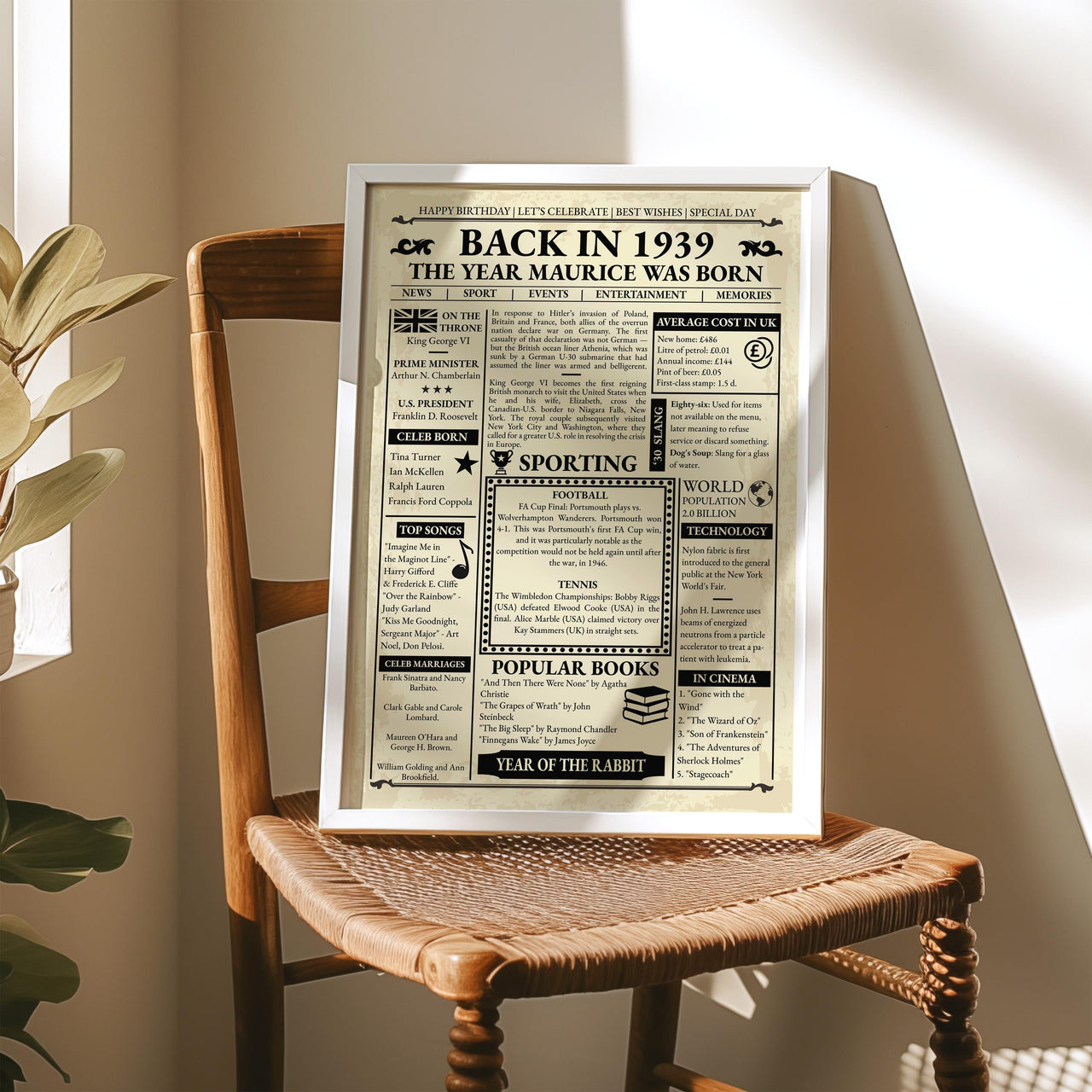 Vintage 1939 birthday newspaper print in a silver frame resting on a wooden chair in sunlight