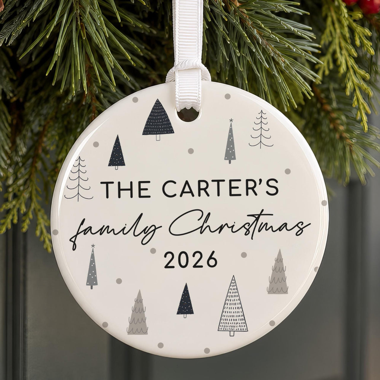 Family name ceramic bauble with grey and navy doodle trees and dots: The Carter's family Christmas 2026, hung on pine
