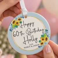 60th birthday ornament: ceramic disc with sunflowers, gold ring, Happy 60th Birthday Holly and Love Nancy & Jaxon