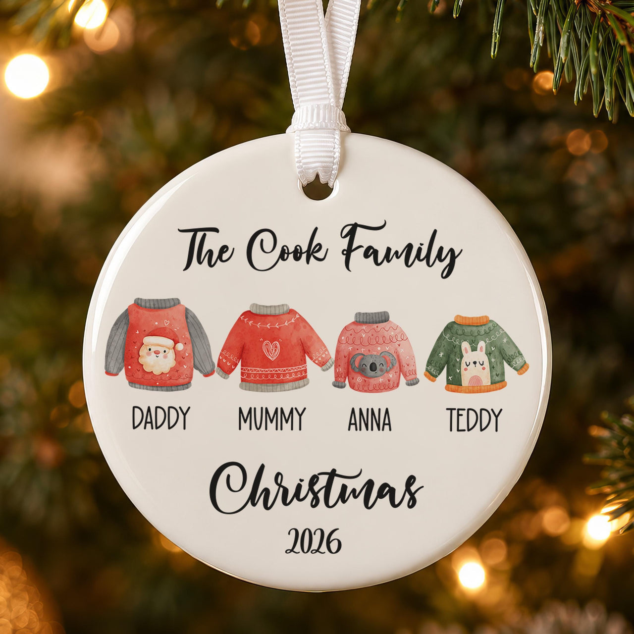Christmas jumper ceramic bauble: four festive jumpers labelled Daddy, Mummy, Anna, Teddy under The Cook Family, 2026