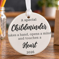 Childminder ceramic ornament: white round bauble with the verse takes a hand, opens a mind and touches a heart, 2026