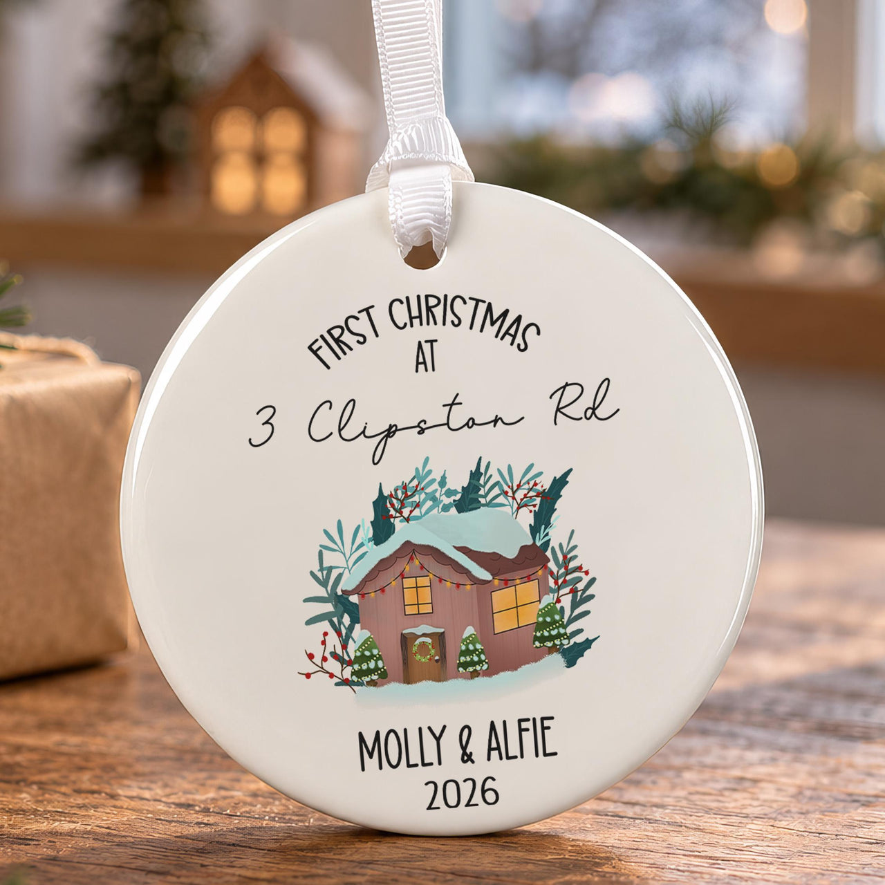 First Christmas ceramic bauble: snowy cabin with fairy lights and trees, 3 Clipston Rd, Molly & Alfie, 2026