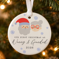Nanny and Grandad ceramic bauble: round, cartoon grandparent faces, blue snowflakes, Our First Christmas As Nanny & Grandad
