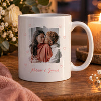 Personalised photo mug: white mug with a couple's photo framed by small pink hearts and Matilda & Samuel in script
