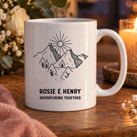 Personalised couple mug: white mug with line-art mountains, sun and trees, ROSIE & HENRY and ADVENTURING TOGETHER