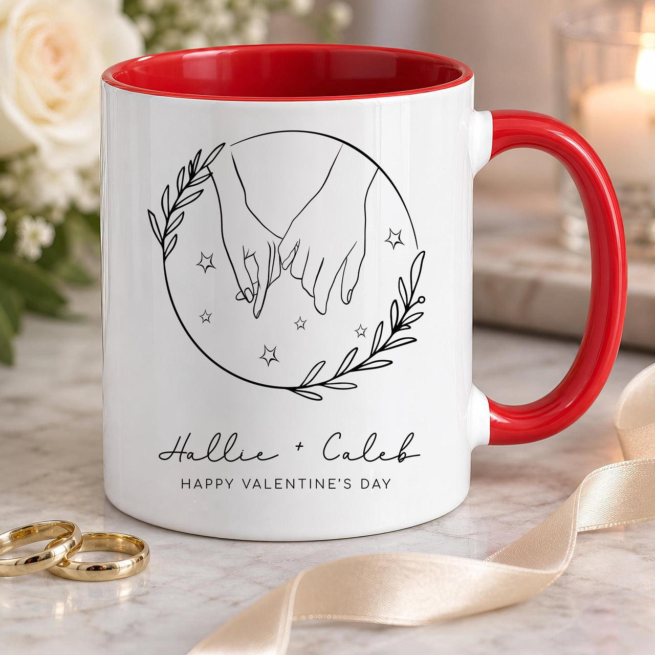 Personalised couple mug: white mug with red handle, line art holding hands in a leafy circle and Hallie + Caleb in script