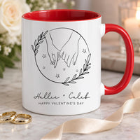 Personalised couple mug: white mug with red handle, line art holding hands in a leafy circle and Hallie + Caleb in script