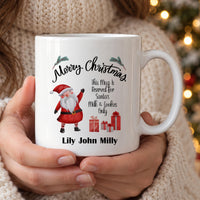 Personalised family Santa mug: white mug with Merry Christmas, a waving Santa, gifts and the names Lily John Milly