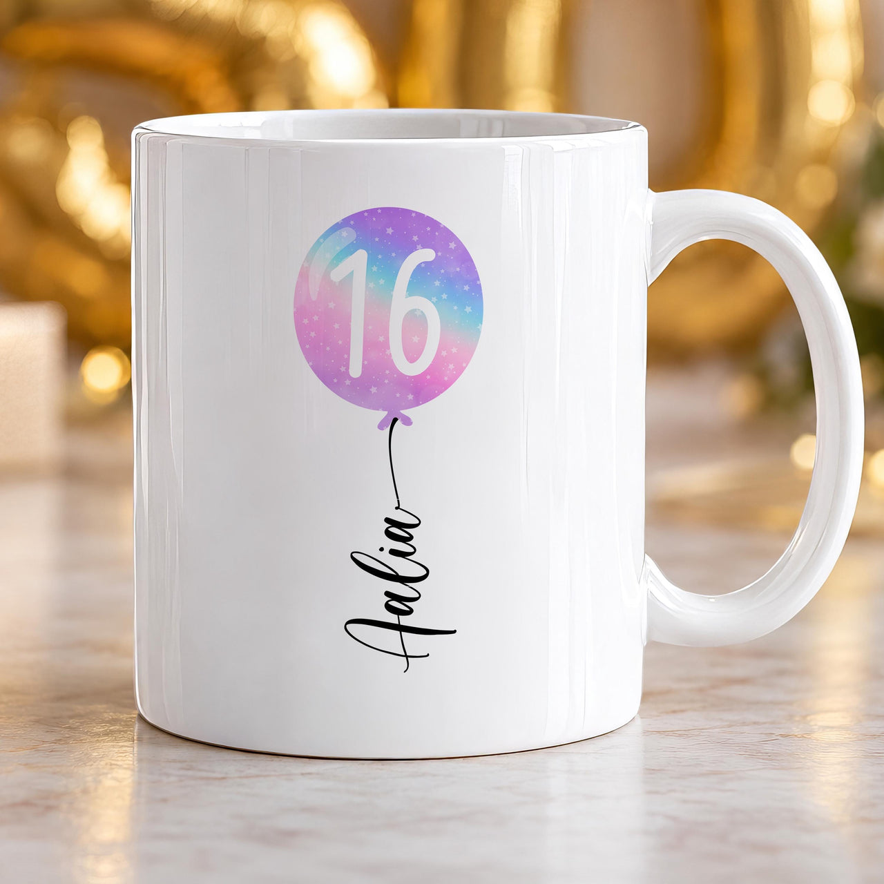 16th birthday mug: white mug with a pastel rainbow balloon showing 16 and the name Aalia in script forming the string