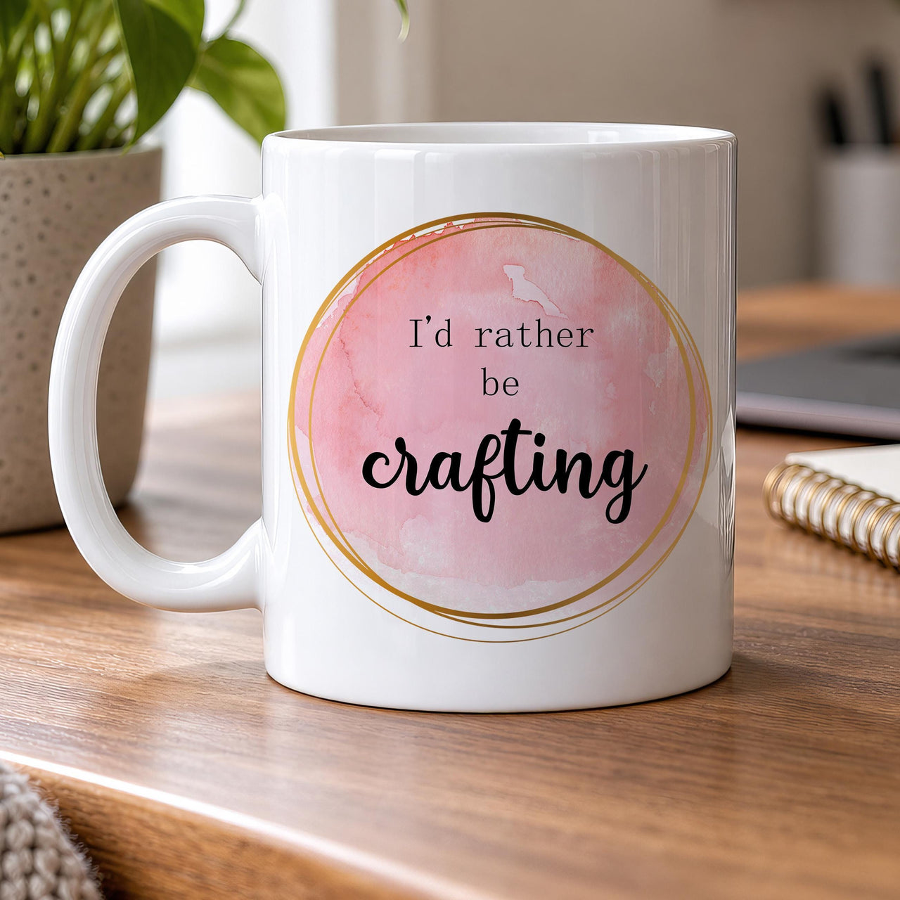 Crafting mug: white mug with a pink watercolour circle in a gold ring and the words I'd rather be crafting