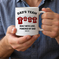 Personalised Dad's Team mug: white mug with red football shirts on a line named DAD, SARAH, EMMA and MUM, and BUILT WITH LOVE