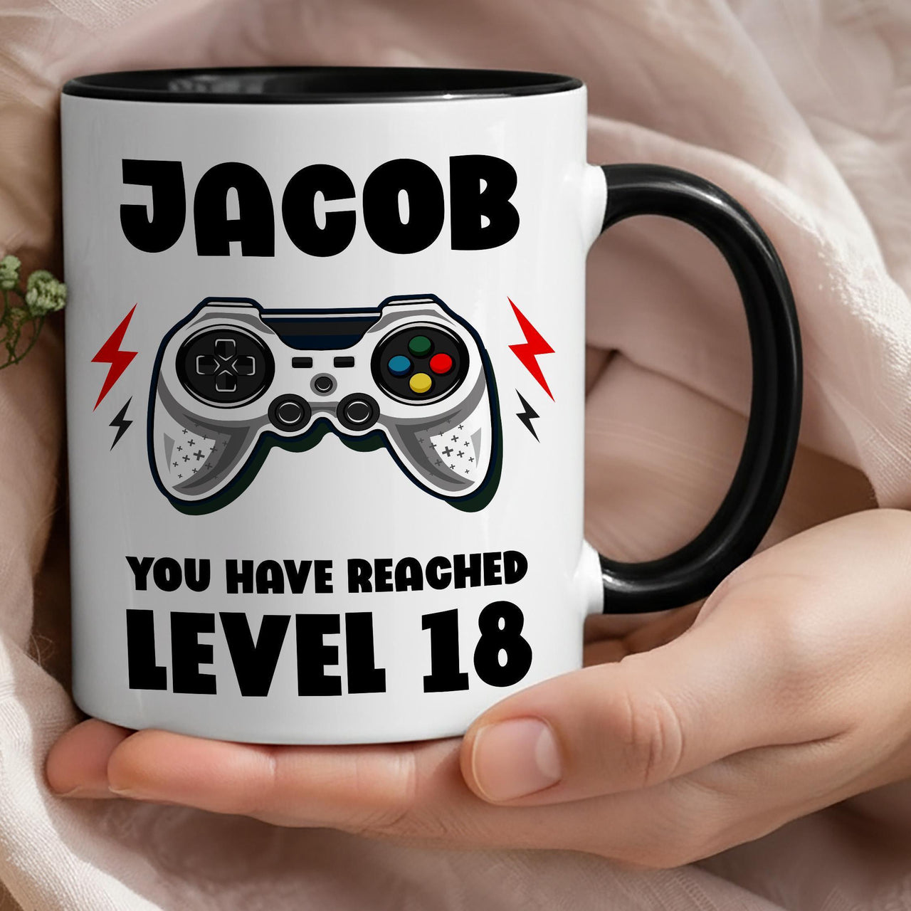 Personalised 18th birthday gamer mug: black-handled mug with JACOB, a game controller and YOU HAVE REACHED LEVEL 18
