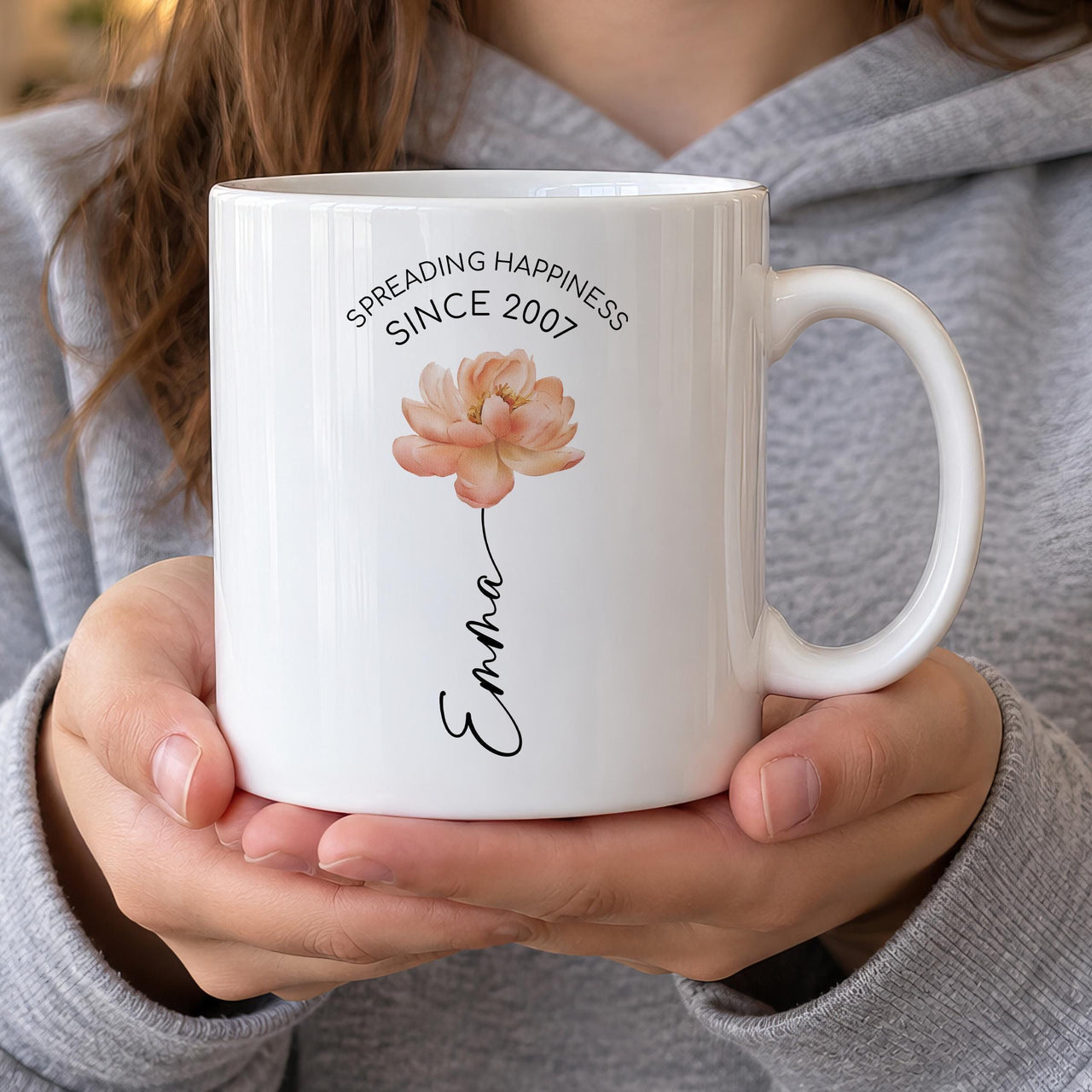 Personalised flower mug: white mug with a peach peony, SPREADING HAPPINESS SINCE 2007 and the name Emma as the stem