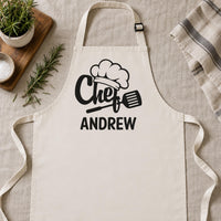 Natural cream apron laid flat with black 