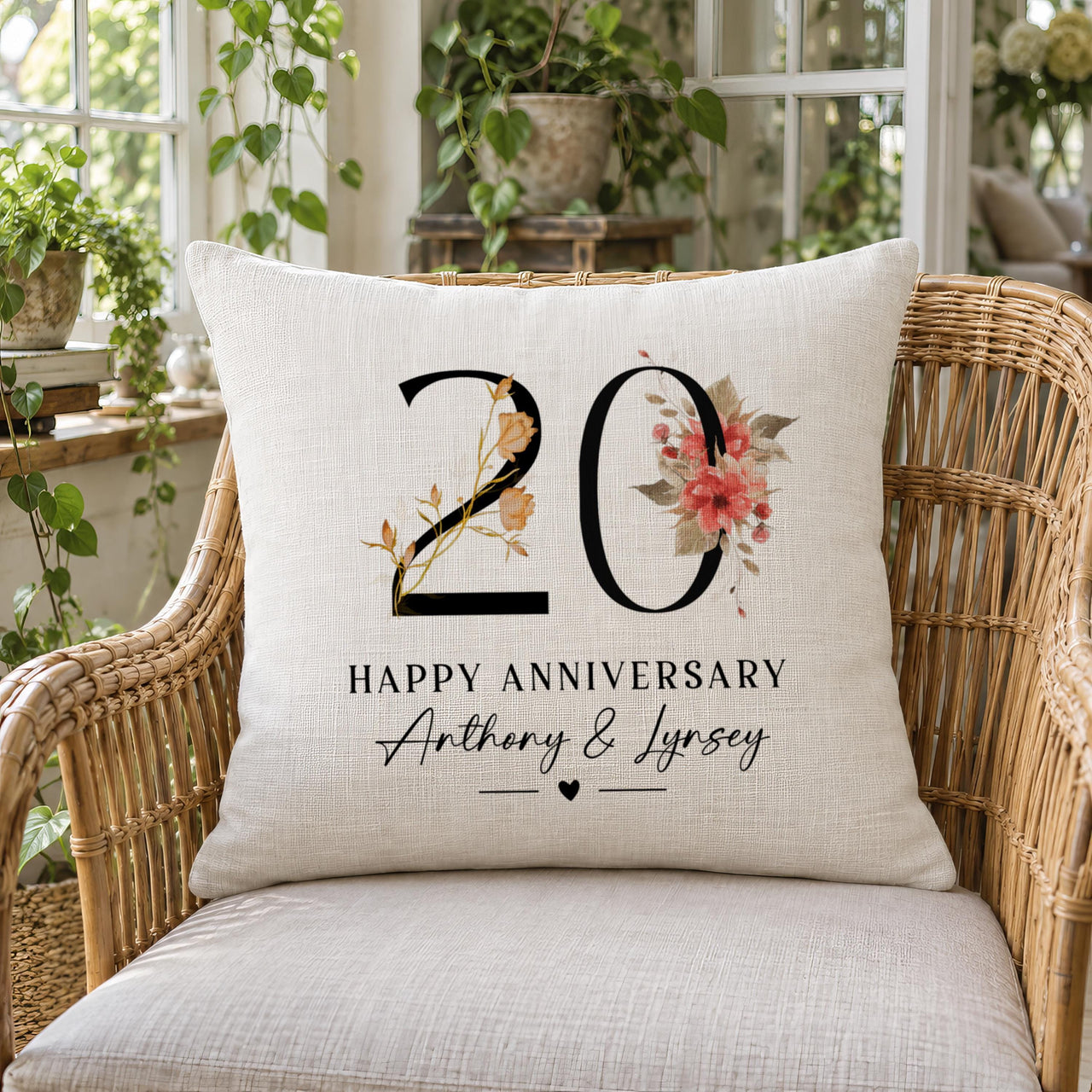 Linen cushion on a wicker chair, warm floral '20', 'HAPPY ANNIVERSARY', 'Anthony & Lynsey' - personalised cushion