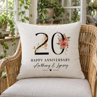 Linen cushion on a wicker chair, warm floral '20', 'HAPPY ANNIVERSARY', 'Anthony & Lynsey' - personalised cushion