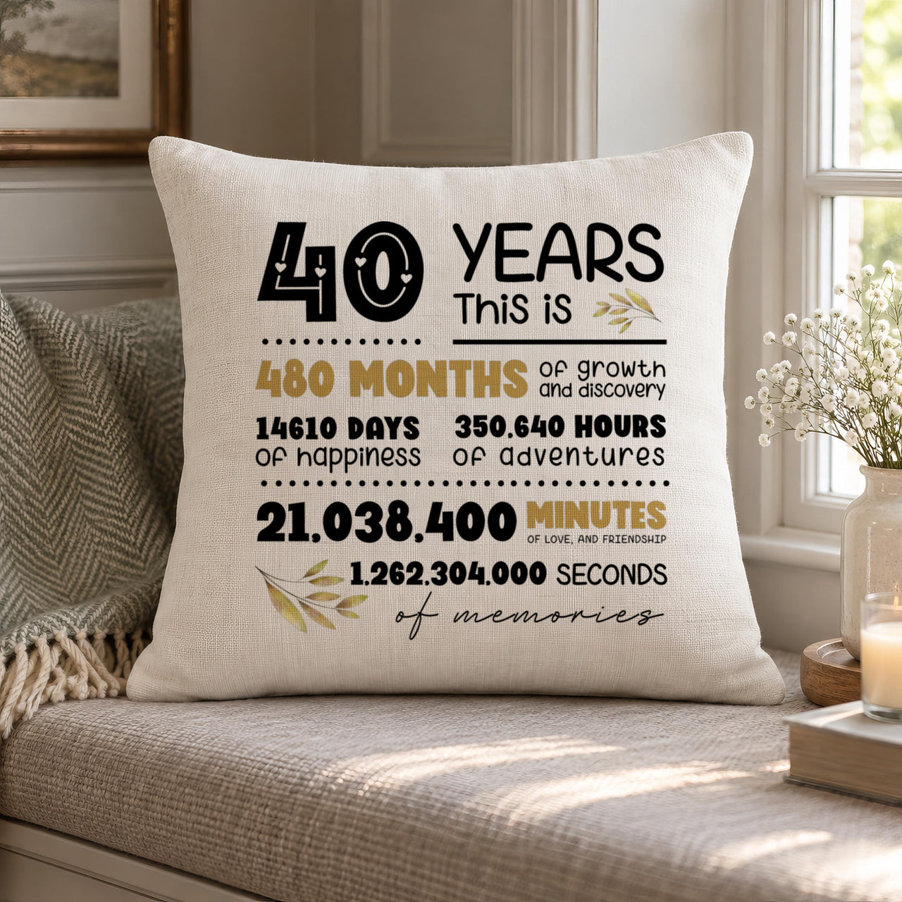 Cream cushion on a window seat with '40 Years This Is' months, days and hours print in black and gold - personalised cushion