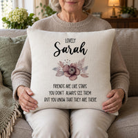 Woman holding a linen-look cushion on her lap printed 'Lovely Sarah' with a friends quote - personalised cushion cover