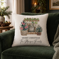 Linen-look cushion on a green velvet sofa with a festive fireplace print and family name - personalised cushion